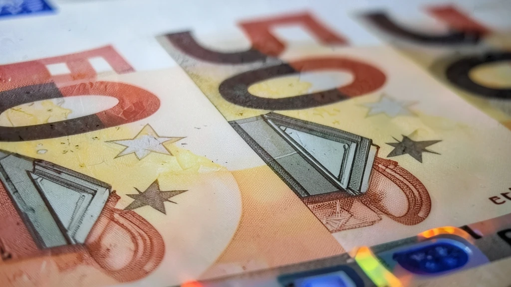 Primer plano macro de varios billetes de 50 euros superpuestos.